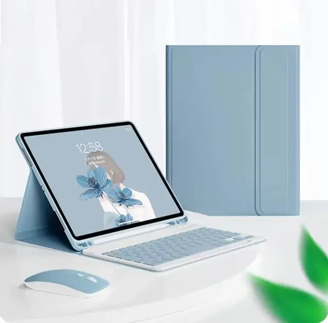 A silver magnetic keyboard case for an iPad Pro is shown next to a laptop and a mouse on a white desk.