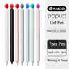 A set of seven colored gel pens in various shades including black, pink, white, and blue, shown vertically.