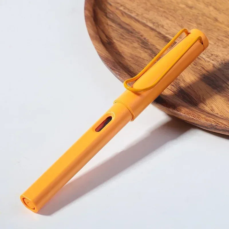 An orange fountain pen is resting on a wooden board.