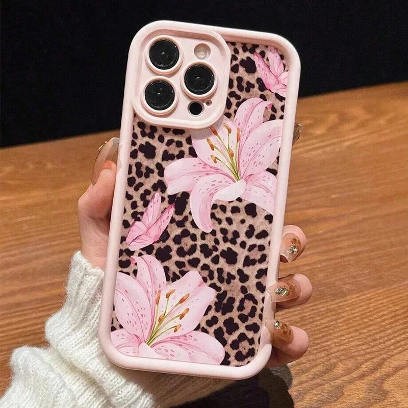 A pink leopard print phone case featuring a large pink lily floral design for an iPhone.