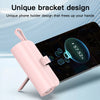 A pink unique bracket phone holder is shown in a close-up against a smartphone screen.