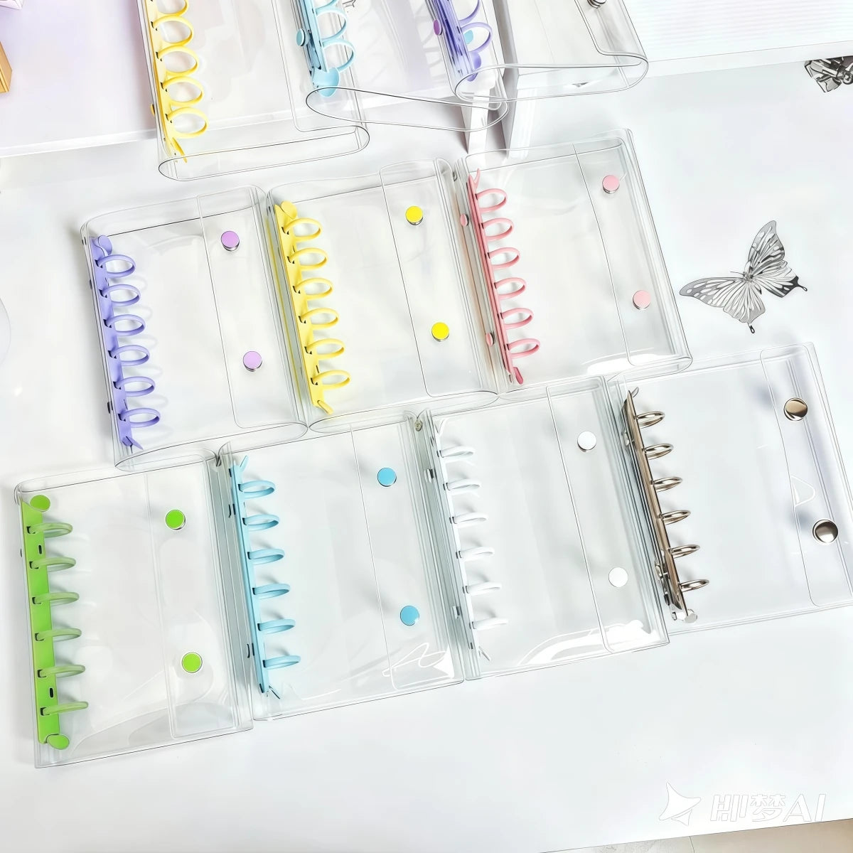 A collection of clear double-button binders in various colors and sizes for stickers and journaling.