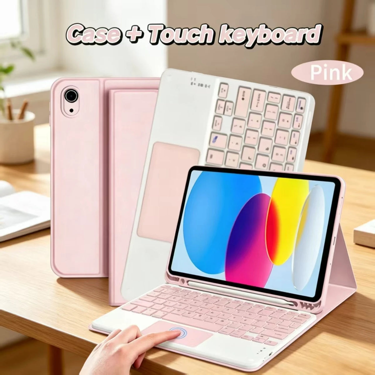 A pink Apple iPad is shown with a matching case and a separate touch keyboard on a wooden table.