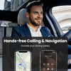 A man is driving and using a smartphone for hands-free calling and navigation in a car.