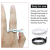 A hand demonstrates how to use a reusable ring sizer tool to determine the correct finger size for a ring.