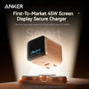Anker First-to-Market 45W Screen Display Secure Charger device shown with an iPhone 17 Pro Max charging on a wooden surface.