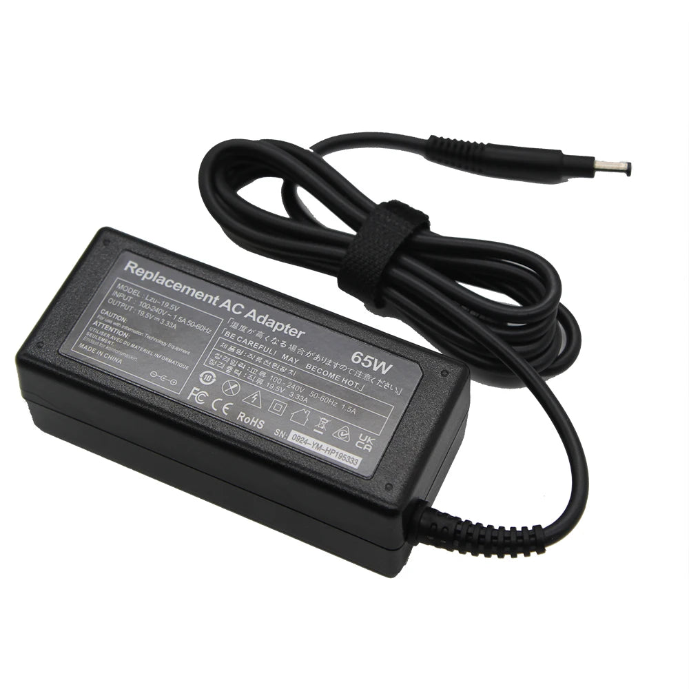Black 65W AC adapter for laptop computers with a coiled power cord and plug.