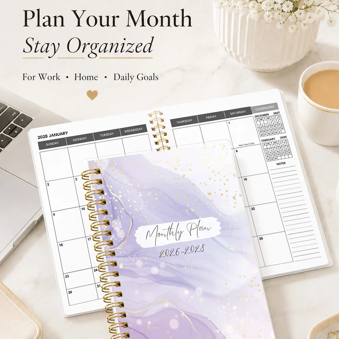 A5 monthly planner for 2026–2028 with a purple marble design and gold spiral binding, placed on a white marble surface.
