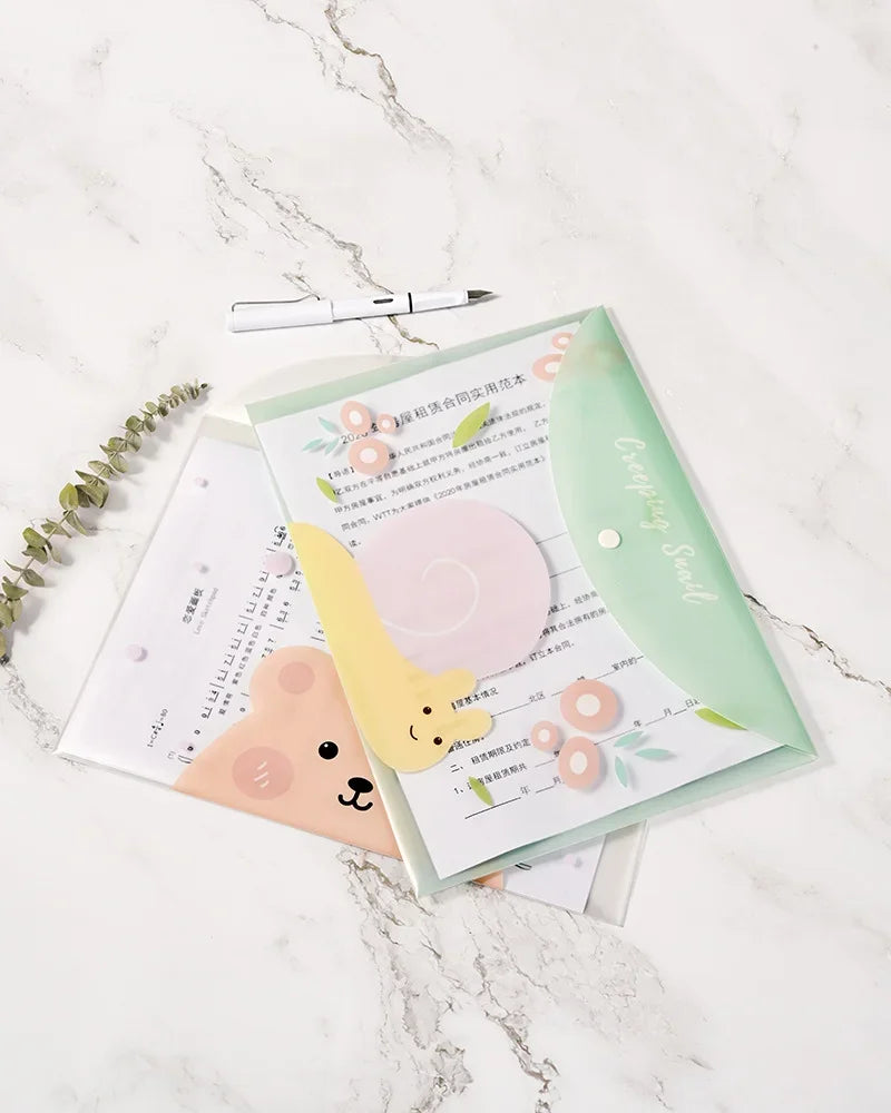 A set of four cute cartoon transparent document pouches for A4 papers displayed on a marble surface.