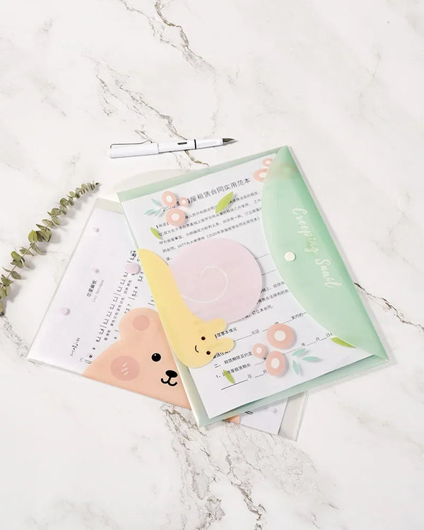A set of four cute cartoon transparent document pouches for A4 papers displayed on a marble surface.
