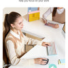 A woman uses an ergonomic vertical wireless mouse on a white desk while working.