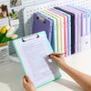 A hand holds an open A4 document storage file box next to a colorful set of photo and document binders.