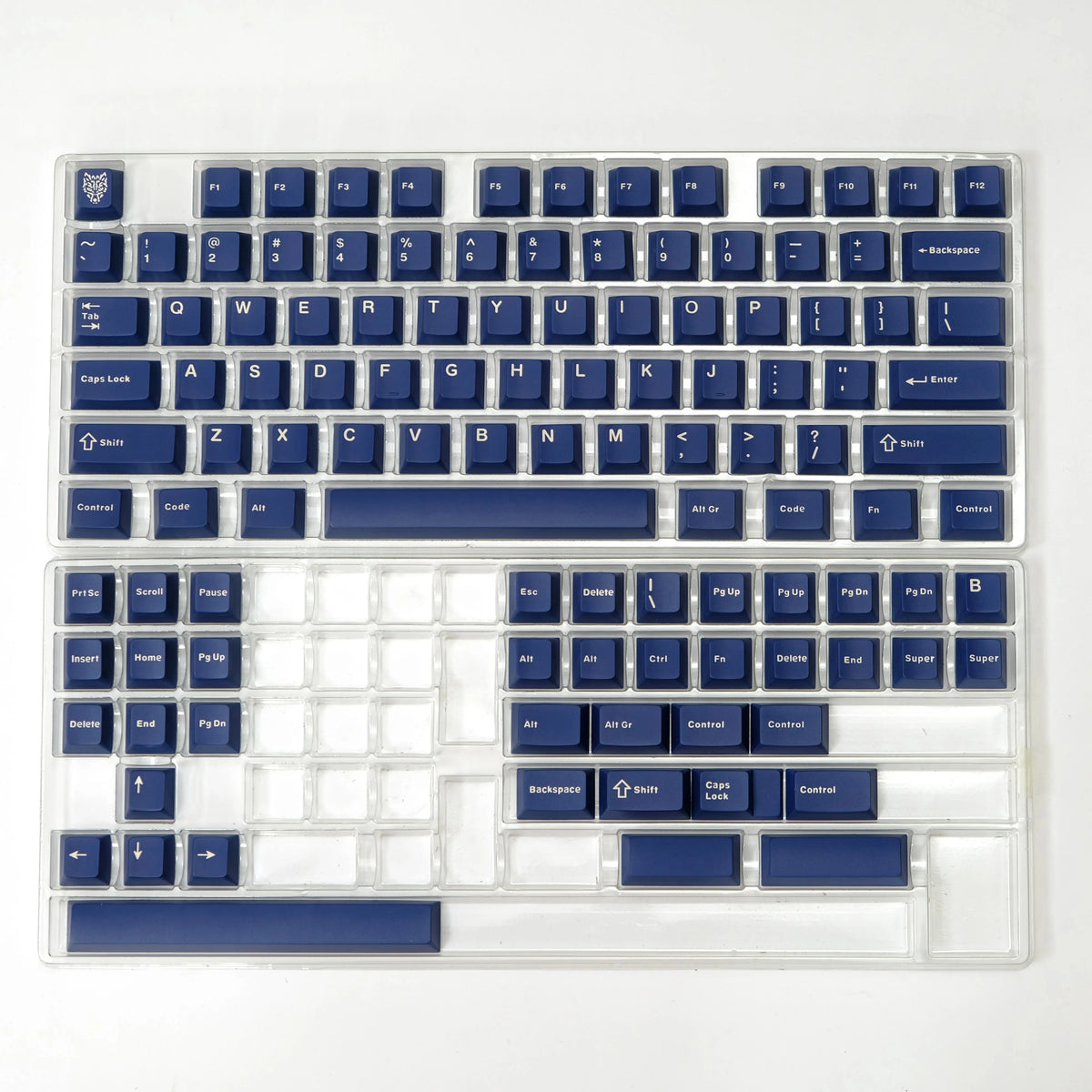 A close-up view of a dark blue PBT mechanical keyboard featuring cherry profile keycaps and a white layout.