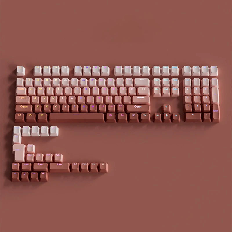 A close-up view of a gradient PBT keycap set for mechanical keyboards in a dusty rose color.