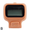 A beige digital counter device with a black screen and an orange body.
