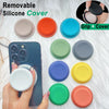 A collection of colorful silicone covers and a phone grip stand are displayed on a white surface.