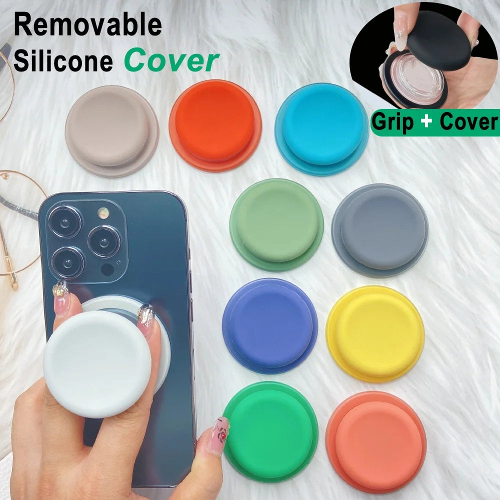 A collection of colorful silicone covers and a phone grip stand are displayed on a white surface.