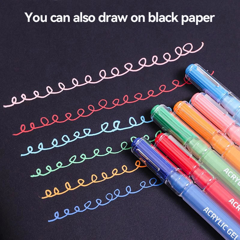 A set of acrylic paint markers with various colored tips drawing wavy lines on black paper.