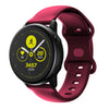 A close-up view of a magenta silicone smartwatch showing a fitness tracking screen with 3457 steps.