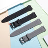 A black silicone watch strap is shown alongside replacement tools on a light blue background.