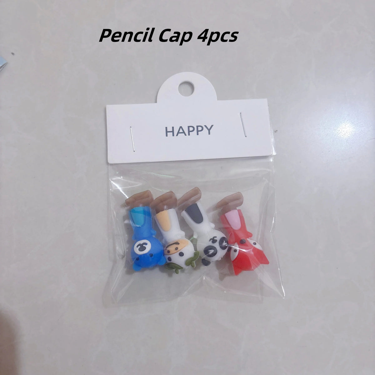 A clear plastic bag contains four colorful silicone pencil grips shaped like animals for children.