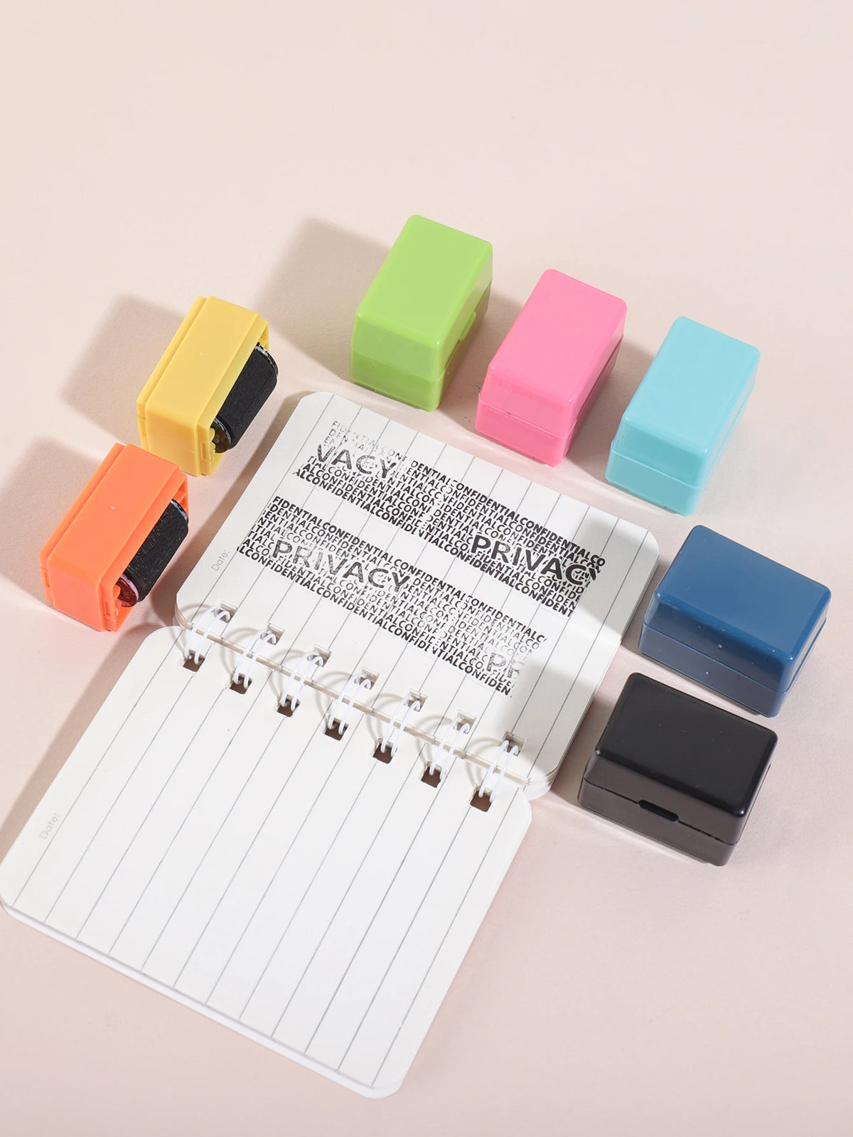 A collection of colorful privacy protection roller stamps in various shades of yellow, green, pink, and blue are arranged on 