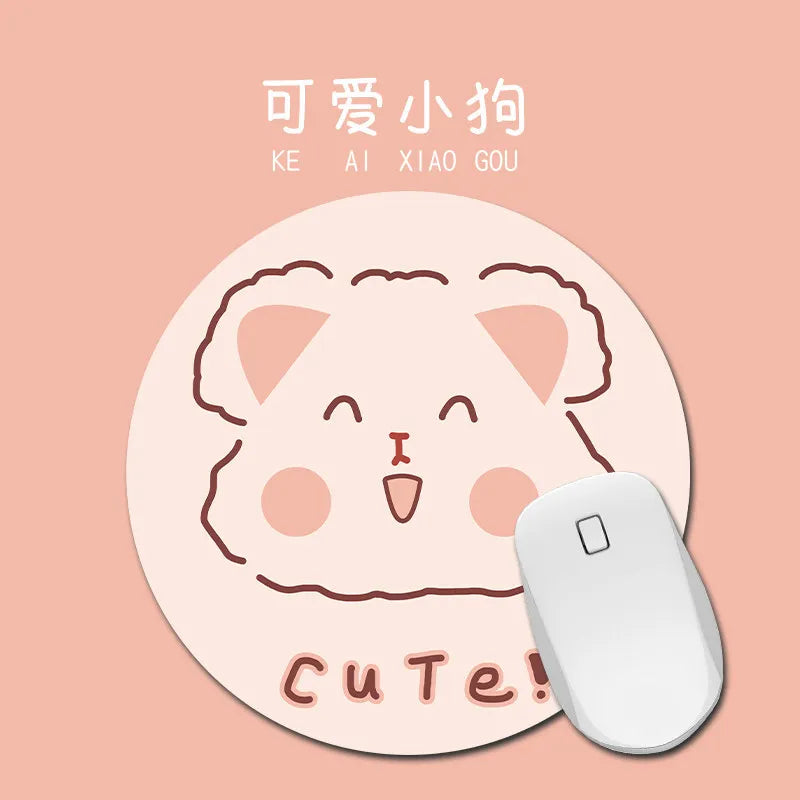 A round, light pink mouse pad featuring a cute cat face design.