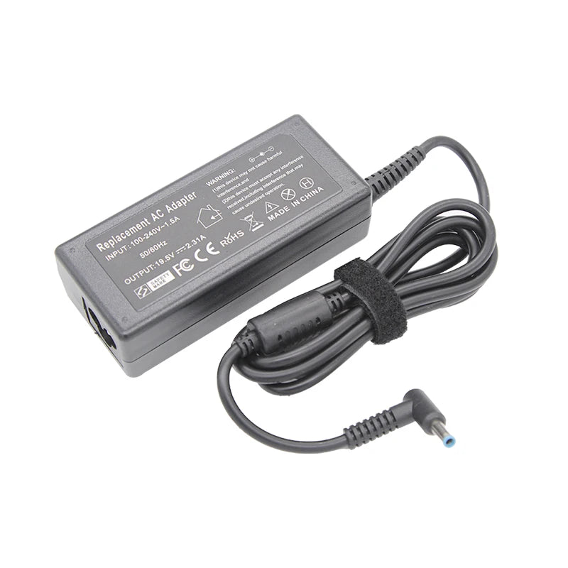 A black AC adapter for a laptop, featuring input and output specifications and a coiled cable.