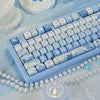 Blue sea themed PBT keycaps for a mechanical keyboard displayed on a light blue cloth.