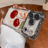 A clear iPhone case with a cherry bow pattern and electroplated finish is held by a person on a wooden surface.