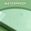 A close-up of a light green document folder with water droplets on its surface, demonstrating waterproof features.