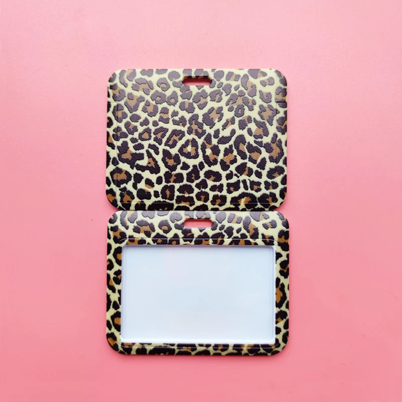 A square ID holder with a leopard print design set against a pink background.