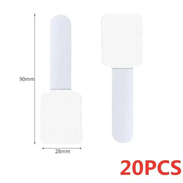 White reusable adhesive cable ties with a cylindrical body and square head for desk organization