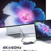 A laptop connected to a monitor displaying a vibrant blue and purple flower, demonstrating a 4K@60Hz immersive display.