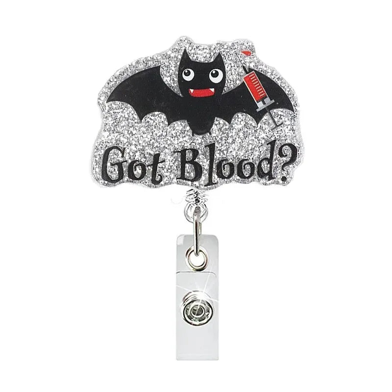 A silver glittery bat-themed charm with the text Got Blood?