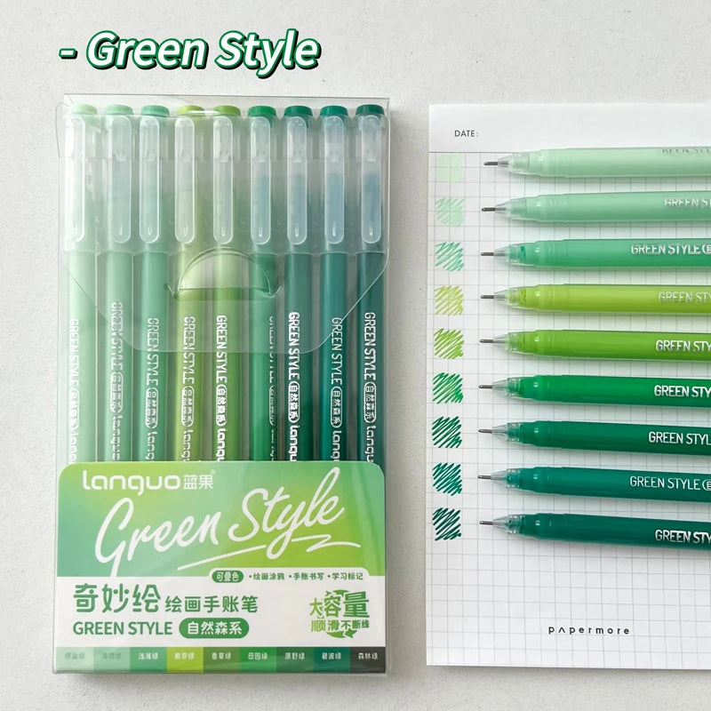 A set of nine green style gel pens is displayed next to a white sheet of paper.