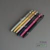 A collection of precision gel pens in various colors and finishes, including gold, silver, pink, purple, and black.