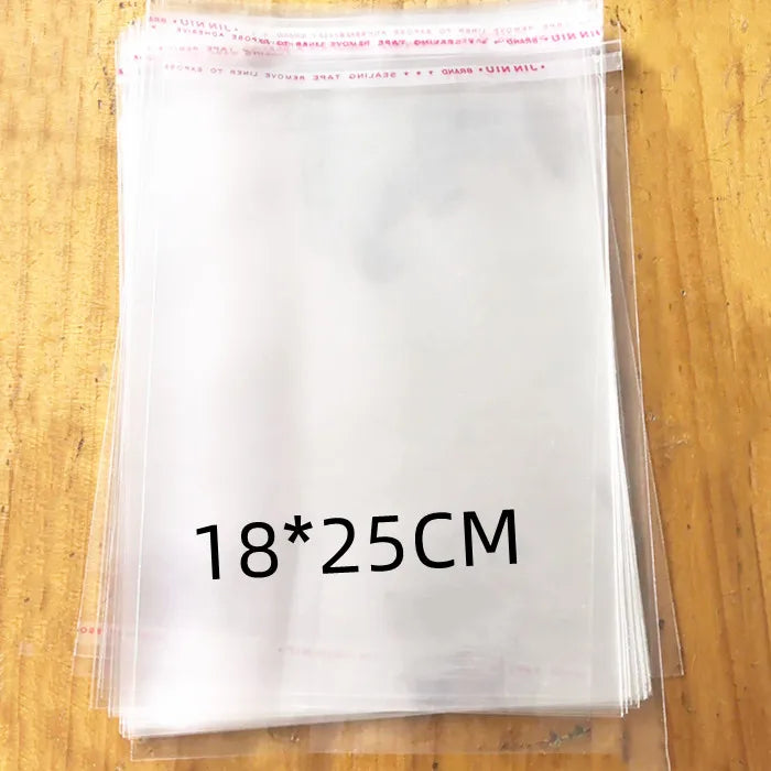 A stack of clear self-sealing plastic bags for jewelry, candy, and gifts is shown on a wooden surface.