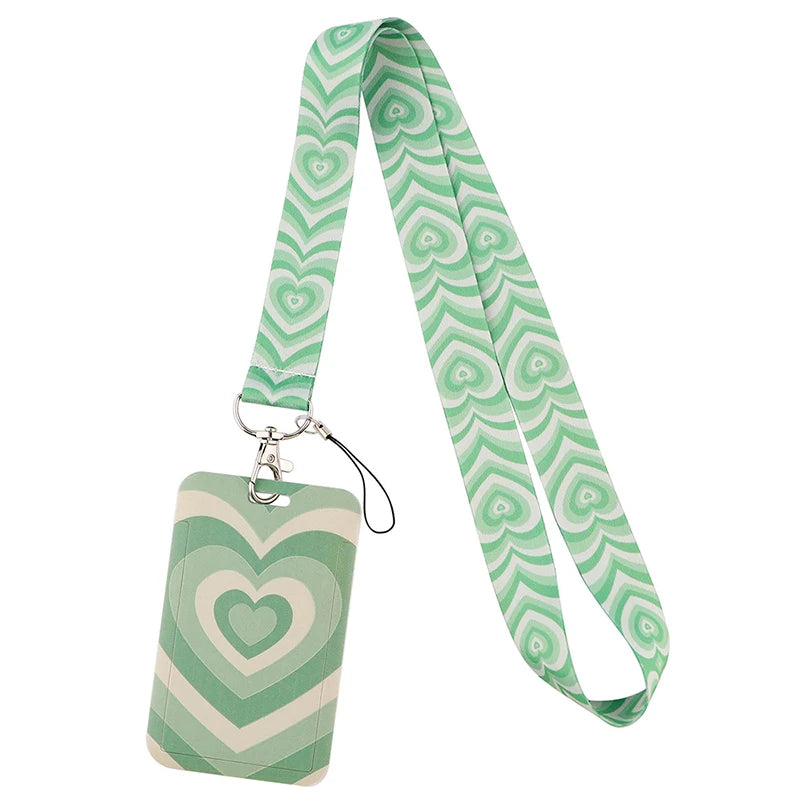 A green and white patterned fabric lanyard for holding ID badges and accessories.