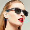 A woman wearing black directional sunglasses with blue sound waves emanating from the lenses.