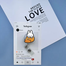 A clear badge reel with a Miffy rabbit charm attached, displayed on a white Instagram post.