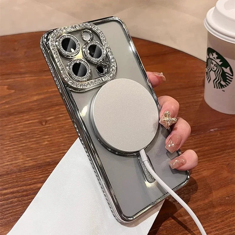 A clear glitter diamond magnetic wireless phone case with multiple camera lenses and a round lens is displayed on a wooden su