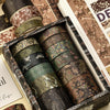 A box of vintage floral washi tape rolls in various shades of green, brown, and gold.