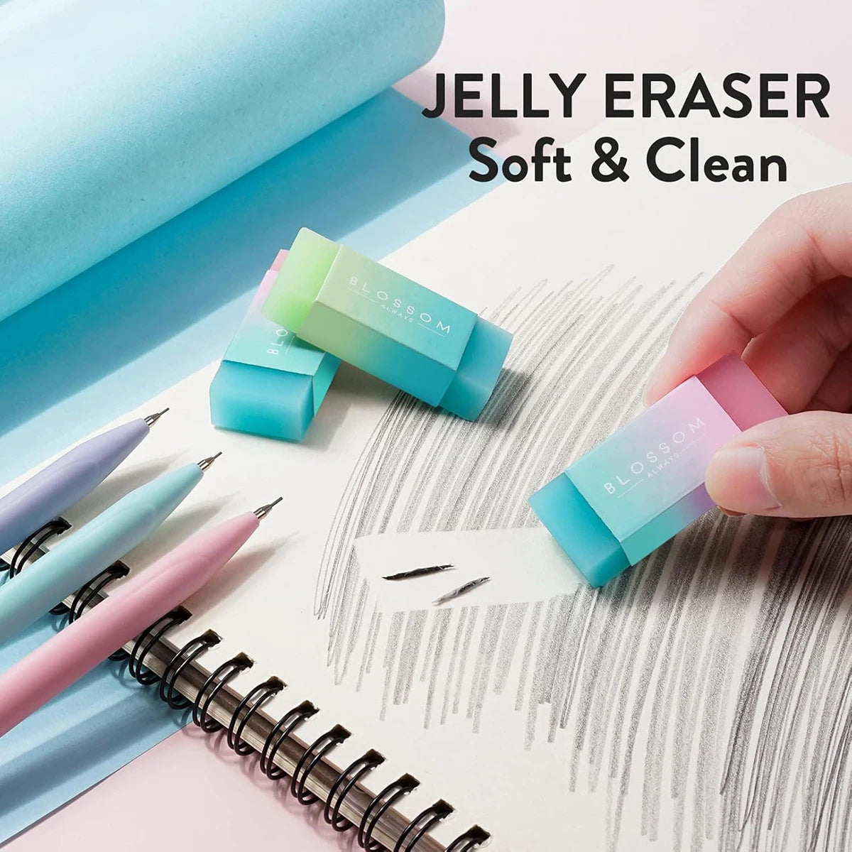 A hand holds a pastel blue jelly eraser, demonstrating the soft and clean texture.
