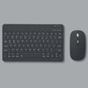 A dark gray multi-device Bluetooth keyboard and mouse combo shown on a flat surface.