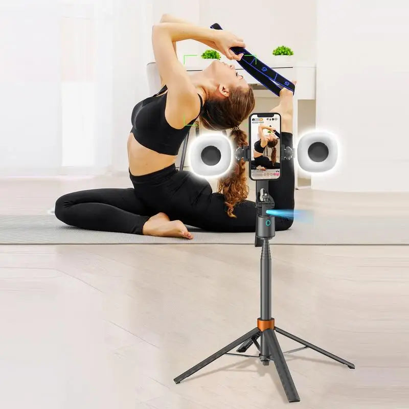 A person is using a 360° rotatable selfie stick tripod with face tracking and dual light to take a photo.