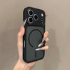A hand holds a black frosted magnetic silicone case for an iPhone, displaying the back panel and camera module.