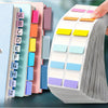 A hand is sorting colorful index tags in a stack of paper for organization.
