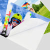A child wearing a yellow helmet and goggles is holding a colorful kite against a blue sky in a grassy outdoor setting.