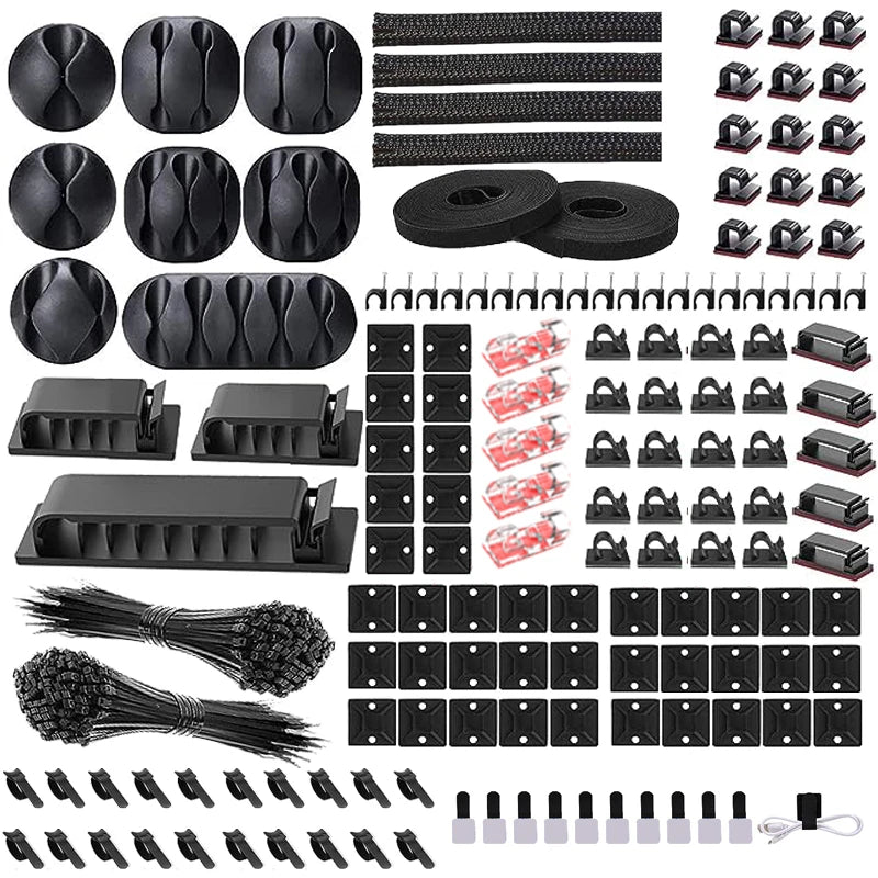 A collection of black cable organizers, including cable ties, clips, and wraps for managing desk cables.